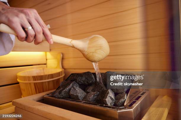 adding steam in sauna! - sauna stock pictures, royalty-free photos & images