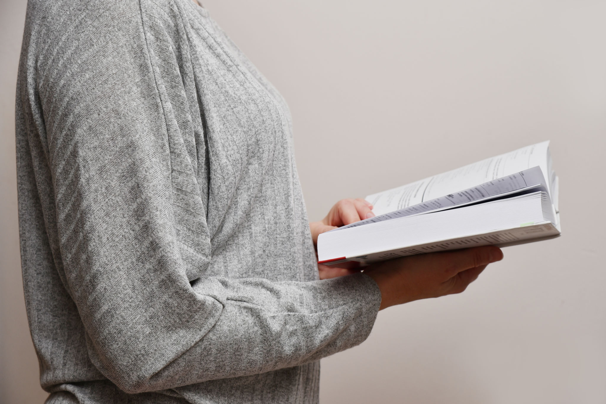 Woman reading a book side view Woman reading a book side view