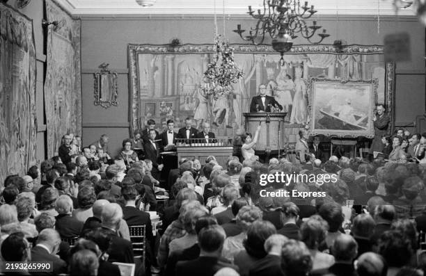 An audience watches an auction of artwork at Sotheby's auction house, London, June 1962.