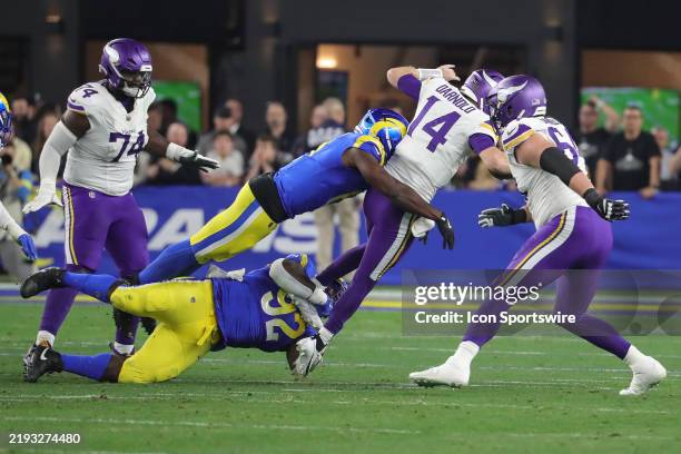 Minnesota Vikings quarterback Sam Darnold gets sacked by Los Angeles Rams defensive tackle Neville Gallimore during the NFC Wild Card Playoff game...