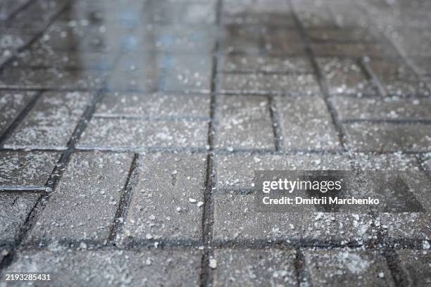 road surface treated with technical salt to prevent ice formation, salt puddles on the road - salz streuen stock-fotos und bilder