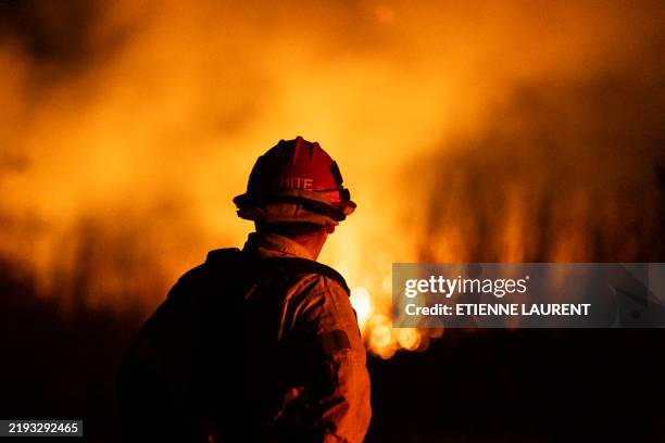 Firefighter monitors the spread of the Auto Fire in Oxnard, North West of Los Angeles, California, on January 13, 2025. US officials warned...