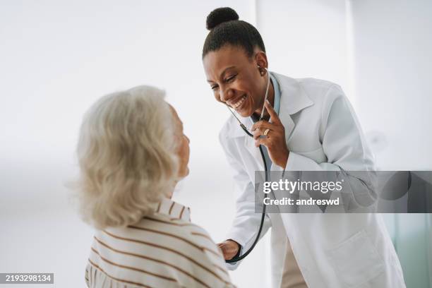 doctor checking patient's heartbeat - health monitoring stock pictures, royalty-free photos & images