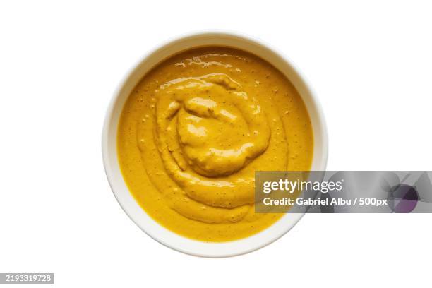 a white bowl containing mustard sauce - mustard stock pictures, royalty-free photos & images
