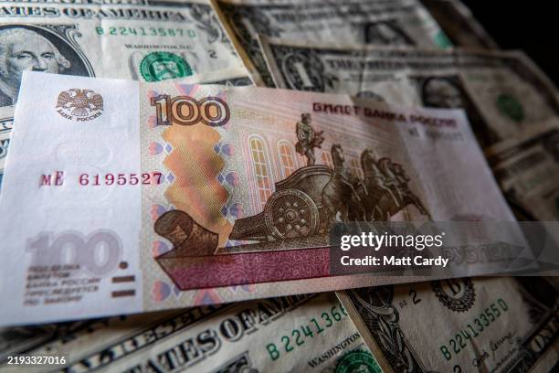 In this photo illustration, Russian rouble notes are seen besides one Dollar bill notes on January 11, 2025 in Bath, England. Although Russia’s...