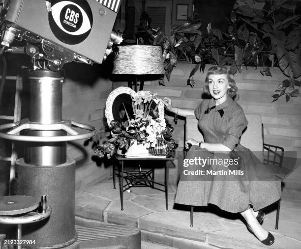 American comedienne, actress, singer and businesswoman Edie Adams sits on the set of the Ernie Kovacs show in the CBS studios in New York, New York,...