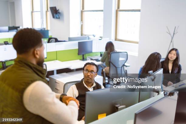 collaborative office environment during daytime - in person stock pictures, royalty-free photos & images