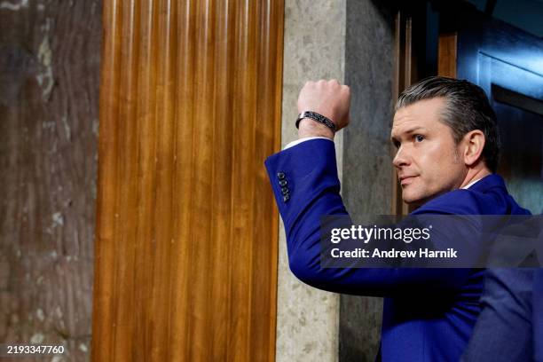 President-elect Donald Trump's nominee for Secretary of Defense Pete Hegseth pumps his fist after a Senate Armed Services confirmation hearing on...