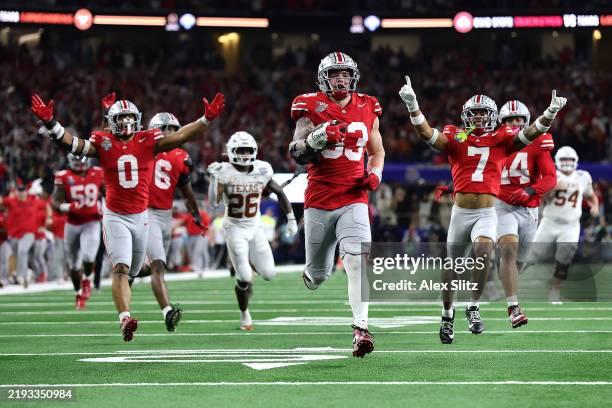 Jack Sawyer of the Ohio State Buckeyes runs with the ball after recovering a fumble in the fourth quarter against the Texas Longhorns during the...