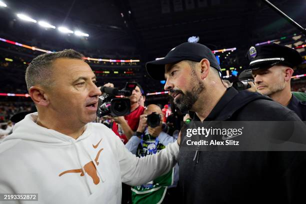 Head coach Steve Sarkisian of the Texas Longhorns and head coach Ryan Day of the Ohio State Buckeyes meet after Ohio State beat Texas 28-14 to win...