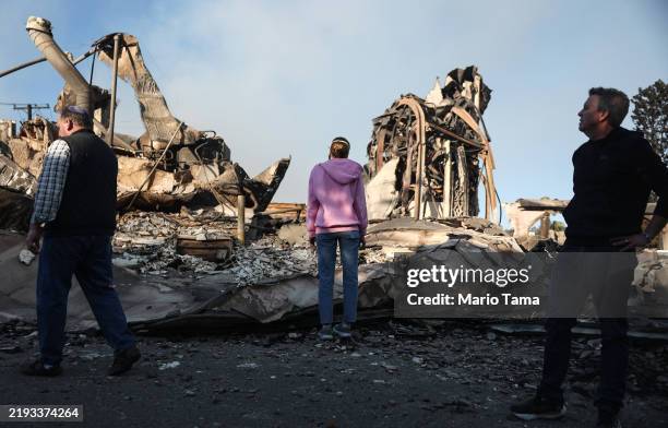 Rev. John Shaver looks on while visiting the remains of Community United Methodist Church, where he is pastor, as wildfires cause damage and loss...