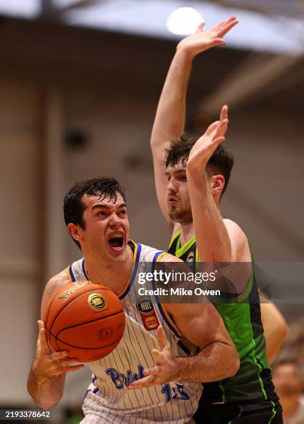 Josh Bannan of the Bullets drives to the basket against Matt Hurt of the Phoenix during the round 16 NBL match between South East Melbourne Phoenix...