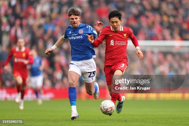 Wataru Endo of Liverpool runs with the ball under pressure from Tyler Walton of Accrington Stanley during the Emirates FA Cup Third Round match...