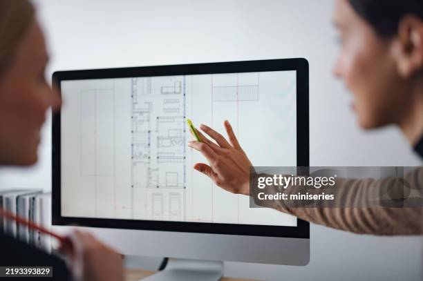 collaborative team discussing architectural design plans on computer screen in office - floor plan stock pictures, royalty-free photos & images
