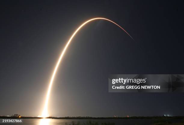 SpaceX Falcon 9 rocket, carrying Firefly Aerospace's Blue Ghost and ispace's Resilience lunar landers, streaks into orbit after lifting off from...