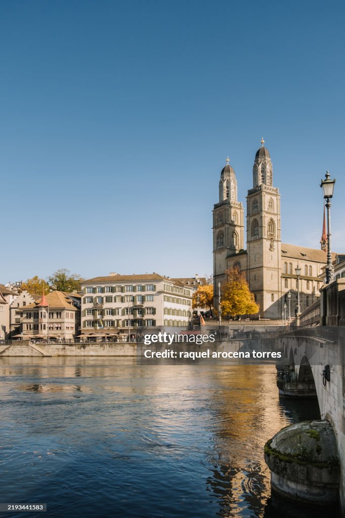 View of the Grossmünster cathedral and the river in Zurich on a sunny day