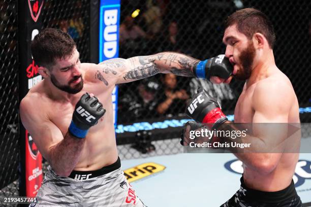 Joe Solecki punches Nurullo Aliev of Tajikistan in a lightweight fight during the UFC Fight Night event at UFC APEX on January 11, 2025 in Las Vegas,...