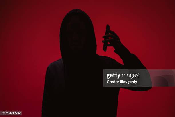 silhouette on red background - suspicion stock pictures, royalty-free photos & images