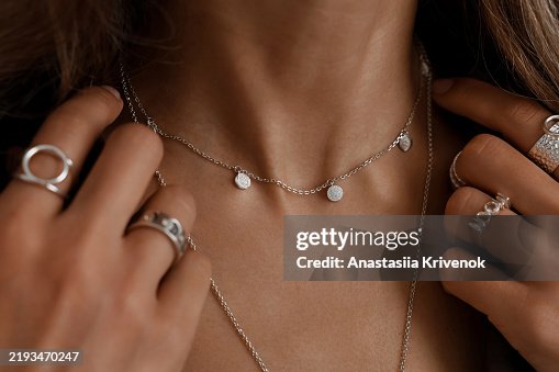 Close up of mysterious woman wearing luxurious silver jewelry. Close up of mysterious woman wearing luxurious silver jewelry.