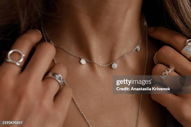 close up of mysterious woman wearing luxurious silver jewelry. - argento foto e immagini stock