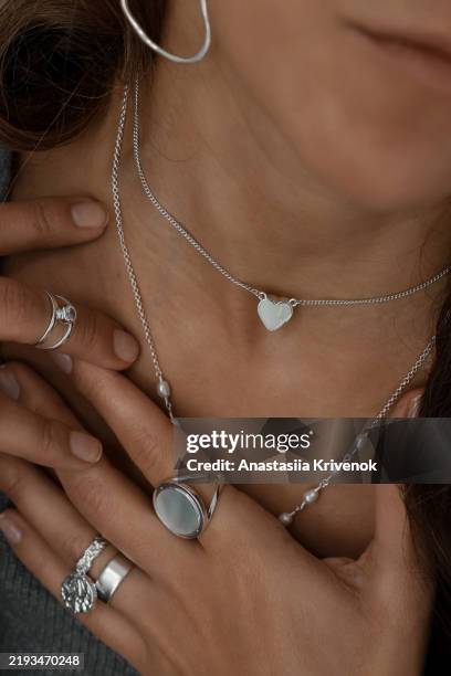 close up of mysterious woman wearing luxurious silver jewelry. - necklace stock pictures, royalty-free photos & images