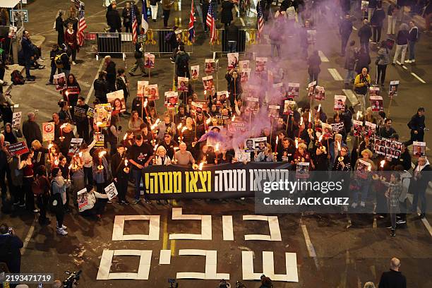 Demonstrators take part in a protest calling for action to secure the release of Israelis held hostage in Gaza since the October 2023, in front of...