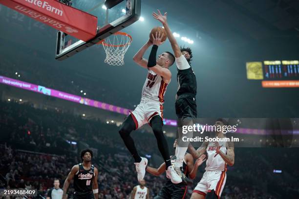Tyler Herro of the Miami Heat shoots the ball past Shaedon Sharpe of the Portland Trail Blazers during the first half at Moda Center on January 11,...