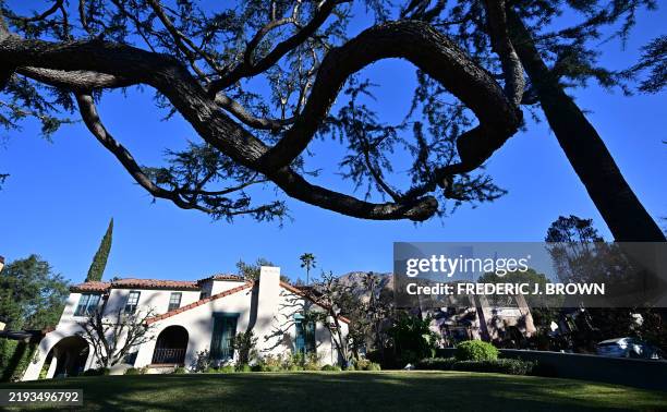 The Walsh House, from the television series "Beverly Hills 90210" remains standing beside a fire-ravaged home in Altadena, California on January 15,...
