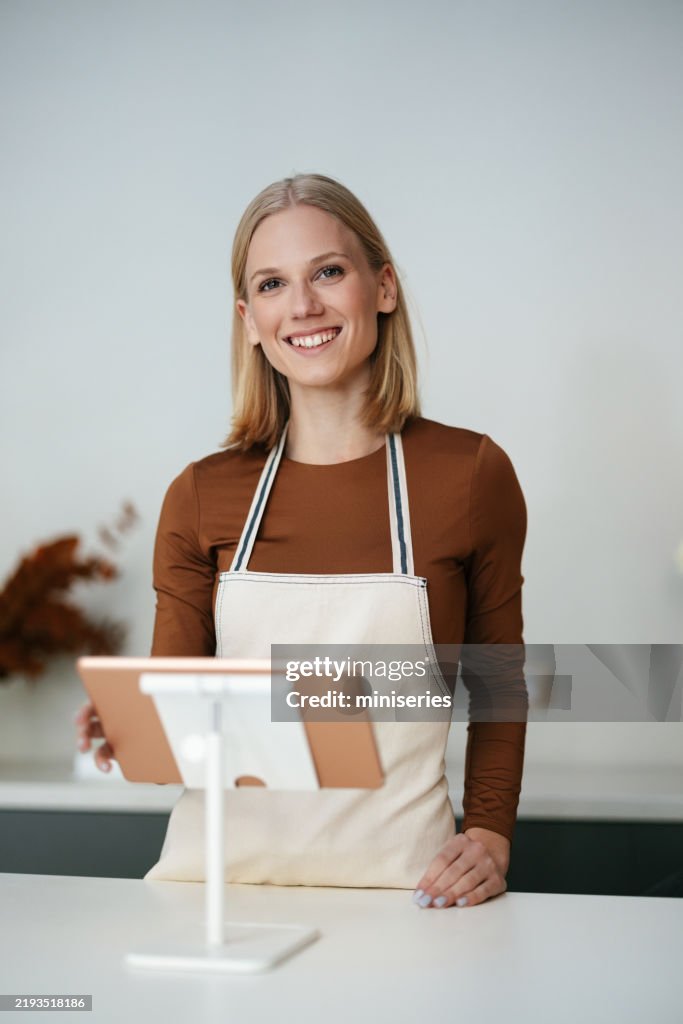 Cheerful Business Woman in Apron Working at Flower Shop Count