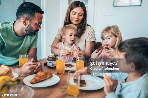 happy family having breakfast - chocolate spread stock pictures, royalty-free photos & images