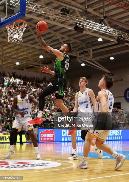 Nathan Sobey of the Phoenix lay ups against Casey Prather, Rocco Zikarsky and Isaac White of the Bullets during the round 16 NBL match between South...