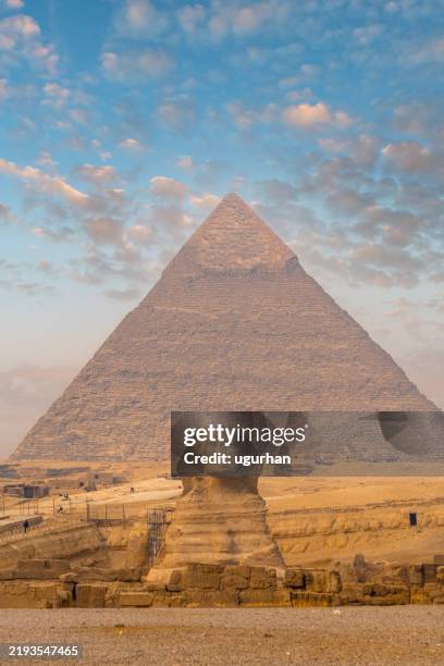 great pyramid of giza and sphinx rising in the early morning light - giza pyramids stock pictures, royalty-free photos & images