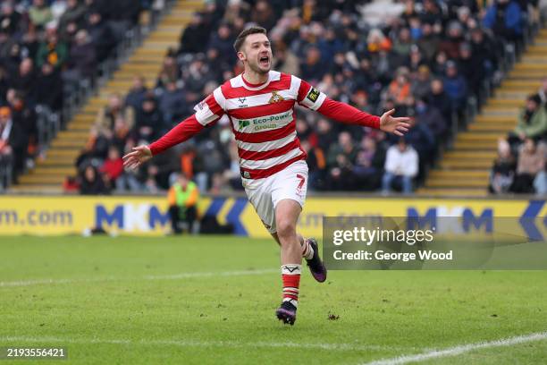 Luke Molyneux of Doncaster Rovers celebrates scoring his team's first goal during the Emirates FA Cup Third Round match between Hull City and...