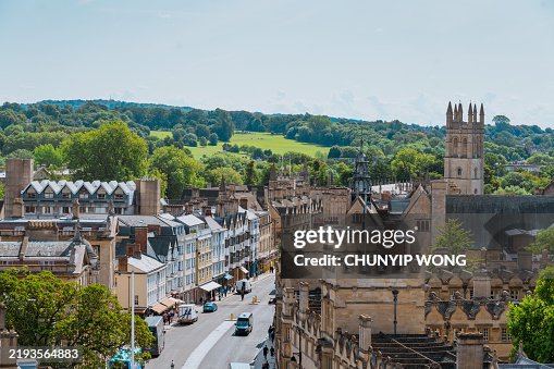 Oxford city center with magdalen tower and lush green hills in background Oxford city center with magdalen tower and lush green hills in background