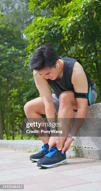 asian man sporting ankle injury - ankle stock pictures, royalty-free photos & images