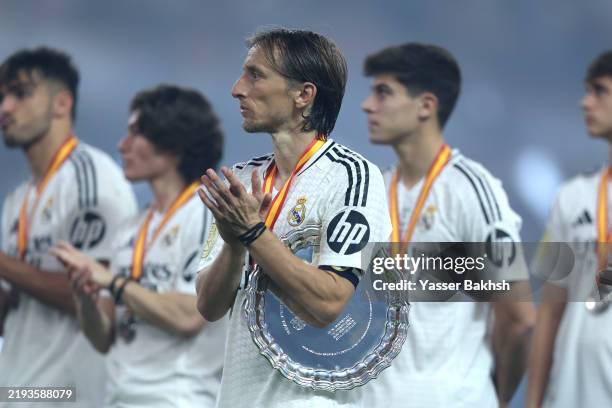 Luka Modric of Real Madrid applauds while holding the Supercopa de Espana runners up shield during the trophy presentation after the Spanish Super...