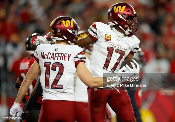 Terry McLaurin of the Washington Commanders celebrates with Luke McCaffrey after scoring a touchdown against the Tampa Bay Buccaneers during the...