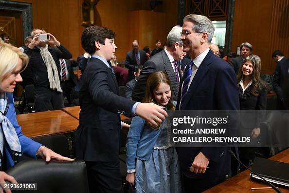 US investor and hedge fund manager Scott Bessent hugs his children at