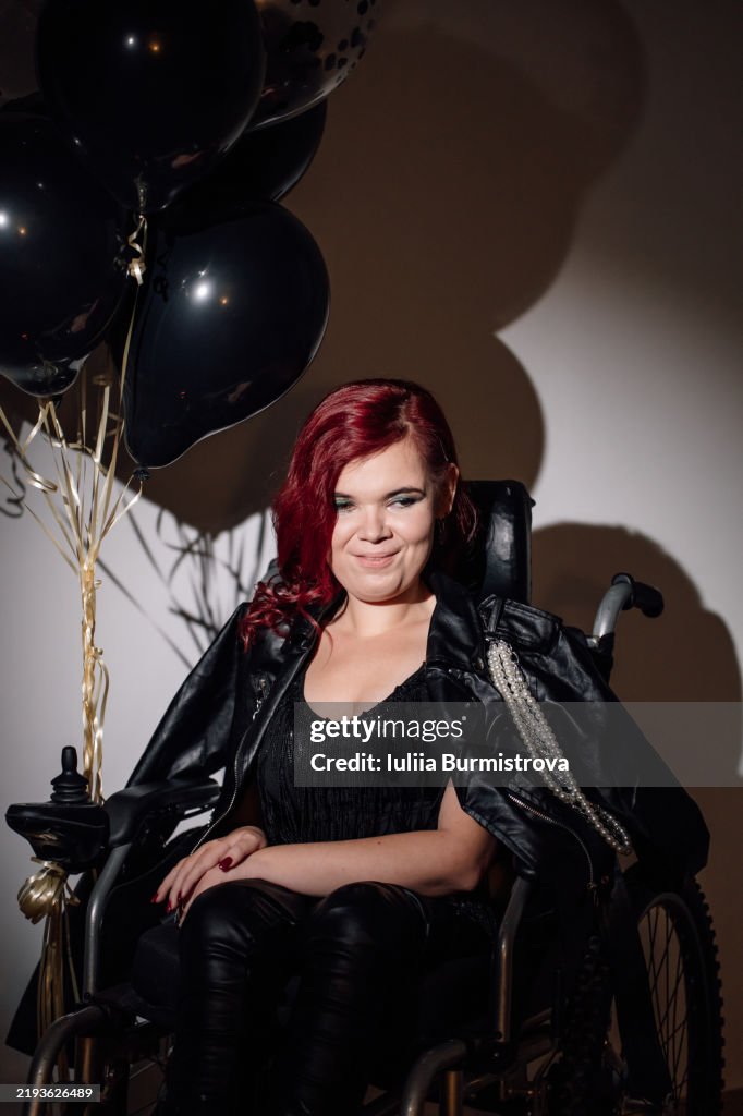 Celebrating life with joy and strength in a wheelchair during a special event at an indoor venue
