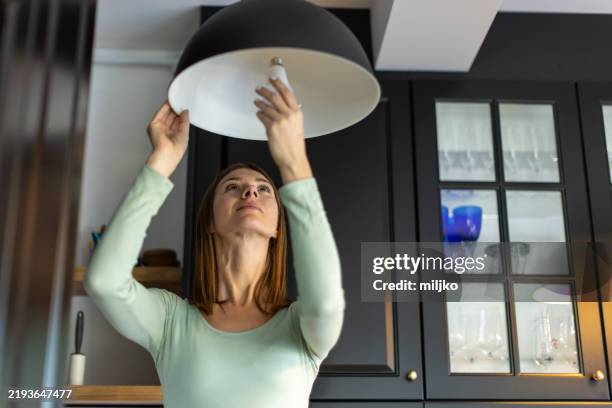 installing an energy efficient light - energiebesparing stockfoto's en -beelden
