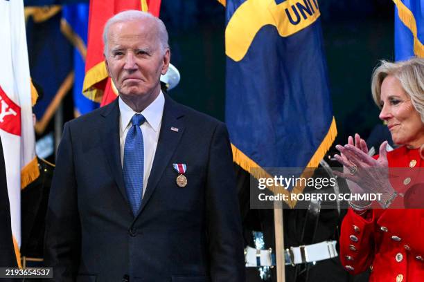 First Lady Jill Biden applauds after US President Joe Biden received a medal at a Department of Defense Commander in Chief Farewell Ceremony at Joint...