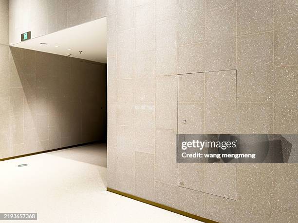 modern minimalist interior with concrete walls and floor - emergency exit light stock pictures, royalty-free photos & images
