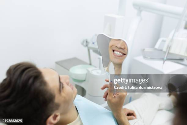 bright smiles in a modern dental clinic during a routine checkup and consultation - sbiancamento dentale foto e immagini stock