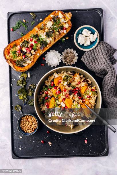 baked butternut squash with rice, feta and pomegranate - feta cheese stock pictures, royalty-free photos & images