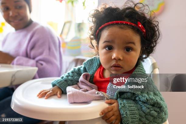 baby girl on a high chair - flickbaby bildbanksfoton och bilder