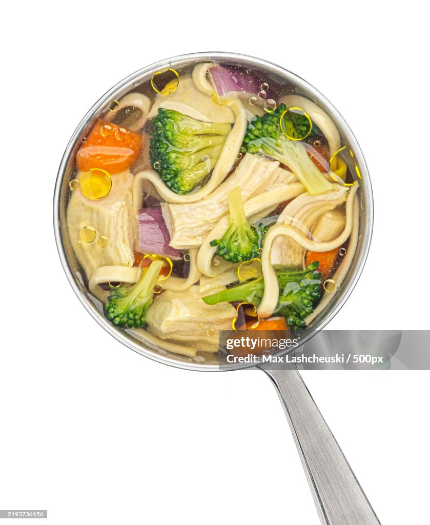 Chicken noodle soup in ladle isolated on white background,Top view