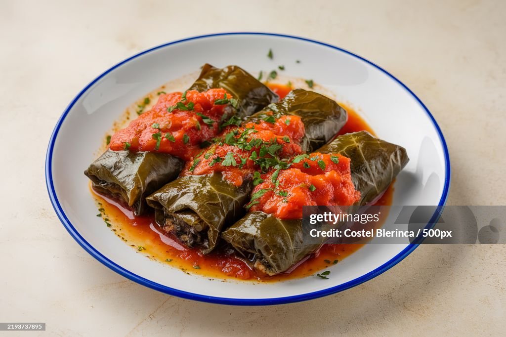 A photo of a plate of dolma,Stuffed grape leaves