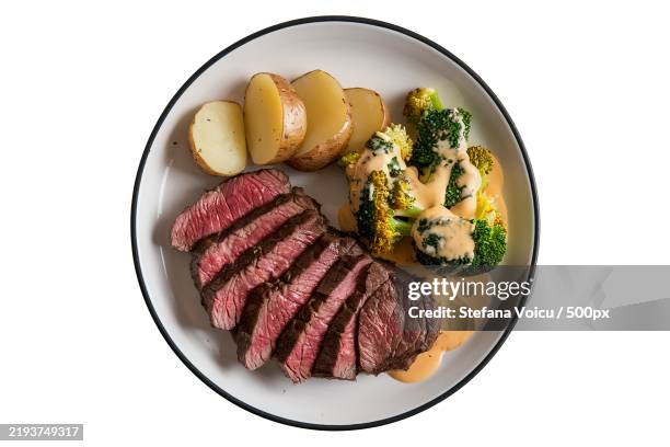 a plate with a medium-rare beef steak,sliced potatoes,and broccoli - paleo diet stock pictures, royalty-free photos & images