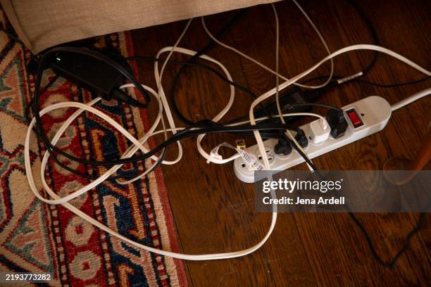 surge protector power strip, messy cables and electrical cords, phone charger cable - elkontakt bildbanksfoton och bilder