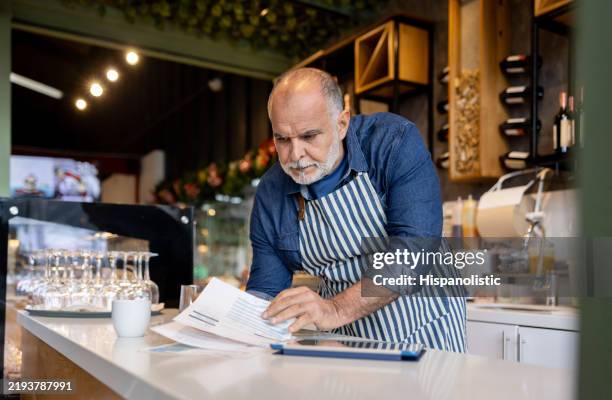 business manager bookkeeping at a cafe - bookkeeping stock pictures, royalty-free photos & images